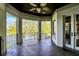 Covered balcony features a ceiling fan, lake view, and access to the home's interior through glass doors at 4726 Ellery Ln, Indianapolis, IN 46250