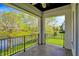 Covered balcony with a view overlooking the water, surrounded by trees, and a lawn at 4726 Ellery Ln, Indianapolis, IN 46250