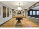 Finished basement with hardwood floors, brick archways, pendant light, and flat screen tv at 4726 Ellery Ln, Indianapolis, IN 46250