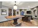 Basement entertainment area with large wood table, bar area, and brick design at 4726 Ellery Ln, Indianapolis, IN 46250