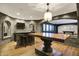 Basement entertainment area with a flat screen TV, bar, stools, and hardwood floors at 4726 Ellery Ln, Indianapolis, IN 46250