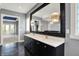 Bathroom featuring double vanity with a large mirror, modern lighting, and access to the rest of the home at 4726 Ellery Ln, Indianapolis, IN 46250