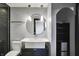 Stylish bathroom with a unique round mirror, modern lighting, and elegant fixtures at 4726 Ellery Ln, Indianapolis, IN 46250