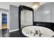 Modern bathroom featuring a large soaking tub, a sleek glass shower, and access to a large walk-in closet at 4726 Ellery Ln, Indianapolis, IN 46250