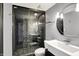 Modern bathroom featuring a glass-enclosed shower with stone accents and updated fixtures at 4726 Ellery Ln, Indianapolis, IN 46250