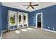 Bright bedroom with a ceiling fan and windows that offer natural light at 4726 Ellery Ln, Indianapolis, IN 46250