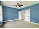 Bedroom featuring calming blue walls and neutral carpet flooring, enhanced by a ceiling fan at 4726 Ellery Ln, Indianapolis, IN 46250