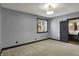 Comfortable bedroom with carpeting, a window, and an en-suite bathroom at 4726 Ellery Ln, Indianapolis, IN 46250