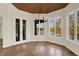 Breakfast nook featuring many windows offering waterfront views, with glass doors that lead to the backyard at 4726 Ellery Ln, Indianapolis, IN 46250