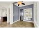 Open dining area with a gray accent wall, tiled floors, and a bar with mirror accents at 4726 Ellery Ln, Indianapolis, IN 46250