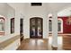 A grand foyer featuring double doors, elegant lighting, and marble flooring, creating a luxurious entrance at 4726 Ellery Ln, Indianapolis, IN 46250