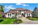 Stately home with a large driveway and beautifully landscaped front yard, set under a clear blue sky at 4726 Ellery Ln, Indianapolis, IN 46250