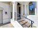 A close-up of the front porch showcasing white pillars, metal railings, and stone stairs leading to the entrance at 4726 Ellery Ln, Indianapolis, IN 46250