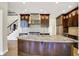 Spacious kitchen with stainless appliances, granite counters, and ample dark wood cabinetry at 4726 Ellery Ln, Indianapolis, IN 46250