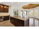Modern kitchen island with granite countertops and views of the breakfast nook and back patio at 4726 Ellery Ln, Indianapolis, IN 46250
