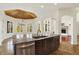 Open concept kitchen island with stone counters, room for seating, and stainless dishwasher at 4726 Ellery Ln, Indianapolis, IN 46250