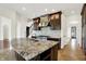 Gourmet kitchen with granite island, modern stainless appliances, and custom dark wood cabinetry at 4726 Ellery Ln, Indianapolis, IN 46250