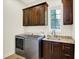 Convenient laundry room with stainless steel appliances, granite countertops, and ample cabinet space at 4726 Ellery Ln, Indianapolis, IN 46250
