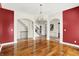 Spacious living room showcasing hardwood floors, white pillars, arched doorways, and an ornate chandelier at 4726 Ellery Ln, Indianapolis, IN 46250
