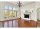 Charming living room with a fireplace, large windows, and an elegant chandelier for a warm ambiance at 4726 Ellery Ln, Indianapolis, IN 46250