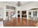 Bright living space with hardwood floors and open floor plan to staircase and kitchen at 4726 Ellery Ln, Indianapolis, IN 46250