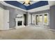 Serene main bedroom featuring a fireplace, tray ceiling, and French doors to a private balcony at 4726 Ellery Ln, Indianapolis, IN 46250