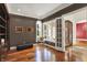 A cozy office space with dark wood walls, built-in shelving, and a comfortable sitting area by the window at 4726 Ellery Ln, Indianapolis, IN 46250