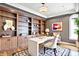 Well-appointed home office featuring built-in shelving, abundant storage, and natural light from a large window at 4726 Ellery Ln, Indianapolis, IN 46250
