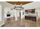 Open floorplan featuring modern kitchen with an island, a fireplace, and travertine floors throughout at 4726 Ellery Ln, Indianapolis, IN 46250