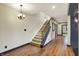 Elegant staircase featuring hardwood floors and neutral walls at 4726 Ellery Ln, Indianapolis, IN 46250