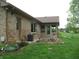 Backyard view of the home showcasing the brick exterior, patio, and well-maintained lawn at 4806 Krestridge E Ct, Bargersville, IN 46106