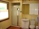 Bathroom featuring wood-look floors, a shower, cabinet and window with white blinds at 4806 Krestridge E Ct, Bargersville, IN 46106