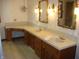 Bathroom featuring dual sinks with decorative mirrors, vintage chandelier, and wood cabinets at 4806 Krestridge E Ct, Bargersville, IN 46106