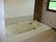 Bathroom featuring an elevated bathtub, cream tiled walls and a window with an outside view at 4806 Krestridge E Ct, Bargersville, IN 46106
