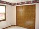 Bedroom featuring floral wallpaper border, closet and window with natural light at 4806 Krestridge E Ct, Bargersville, IN 46106