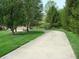 Long, curved driveway surrounded by lush greenery and mature trees leading up to the house at 4806 Krestridge E Ct, Bargersville, IN 46106