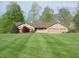 Charming brick ranch home featuring a large, manicured front lawn and two-car garage at 4806 Krestridge E Ct, Bargersville, IN 46106