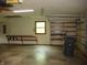 Functional garage features built-in shelving, workbench, natural light, and garage door access at 4806 Krestridge E Ct, Bargersville, IN 46106