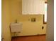 Laundry room with a white utility sink, white cabinets and wood-look floors at 4806 Krestridge E Ct, Bargersville, IN 46106