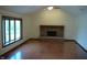 Spacious living room with vaulted ceilings, a brick fireplace, and large bay window at 4806 Krestridge E Ct, Bargersville, IN 46106