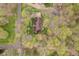 A beautiful aerial view of a home nestled among lush trees providing privacy at 5001 Woodrose Ln, Anderson, IN 46011