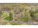 Aerial view of a home surrounded by vibrant green trees in a peaceful, wooded setting at 5001 Woodrose Ln, Anderson, IN 46011