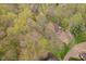 A beautiful aerial view of a home nestled among lush trees providing privacy at 5001 Woodrose Ln, Anderson, IN 46011