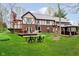Charming backyard with a spacious deck, gazebo, fire pit, and ample green space at 5001 Woodrose Ln, Anderson, IN 46011