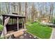 Lush backyard featuring a hot tub gazebo, playhouse, shed, and a well-manicured lawn at 5001 Woodrose Ln, Anderson, IN 46011