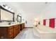 Bathroom with a soaking tub, double vanity, and wooden cabinetry with decor at 5001 Woodrose Ln, Anderson, IN 46011
