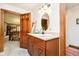 Bathroom featuring wood cabinet vanity, granite countertop, and an oval mirror with decorative lighting above at 5001 Woodrose Ln, Anderson, IN 46011