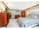 Bedroom features a queen bed, wood trim, two dressers, and neutral-colored carpet at 5001 Woodrose Ln, Anderson, IN 46011