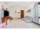 Bedroom featuring seating and wood accents, with neutral carpet and a large window at 5001 Woodrose Ln, Anderson, IN 46011