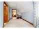 Bonus room with wood trim, built-in shelving, and carpet flooring, with doorway view at 5001 Woodrose Ln, Anderson, IN 46011